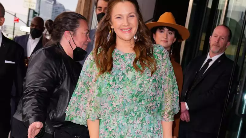 Drew Barrymore laughing in the rain, it's a moment of pure joy