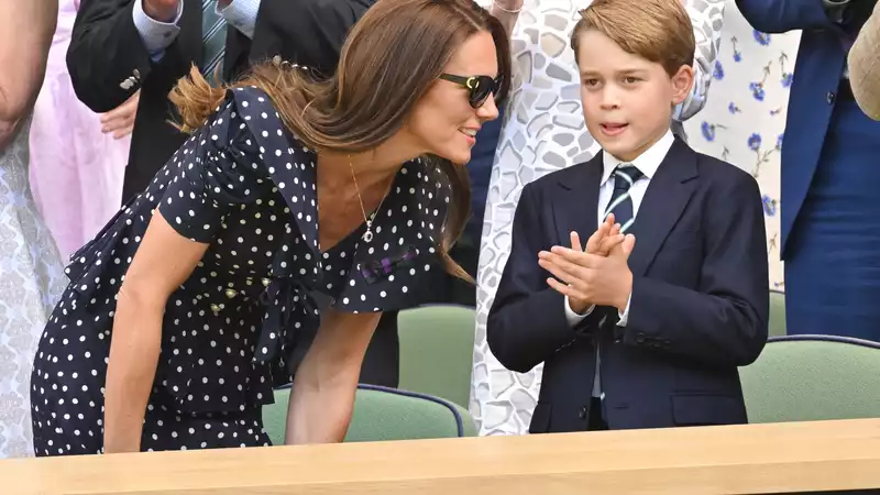 Prince George with the Novak Djokovic trophy, chatting with the Cambridge couple.