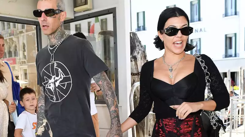 Kourtney Kardashian "won't leave" Travis Barker's side while he is being treated for "extreme stomach pain."