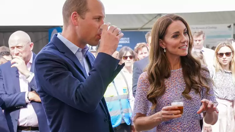 Kate Middleton and Prince William drink beer and play soccer after the unveiling of their portraits.