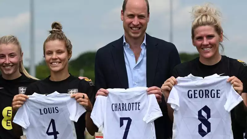 Prince William says Princess Charlotte is a "rising star" in soccer during visit to England women's team.