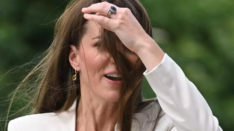 Kate Middleton maneuvers a gust of wind with aplomb in her latest outing.