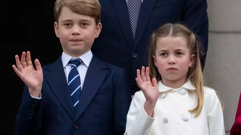 Princess Charlotte corrects Prince George's posture on the balcony of Buckingham Palace.