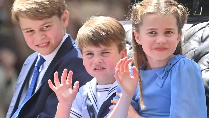 Princess Charlotte tries (but unsuccessfully!) to stop her brother Prince Louis from waving to her during a carriage procession.