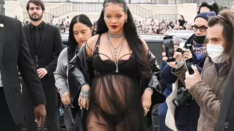 Rihanna shows off a sheer lingerie look at Paris Fashion Week.