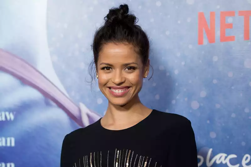 Gugu Mbatha-Raw says she would consider playing Meghan Markle in "The Crown".