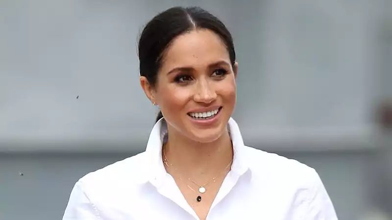 Meghan Markle in conversation with Gloria Steinem wearing striped pants by Anine Bing