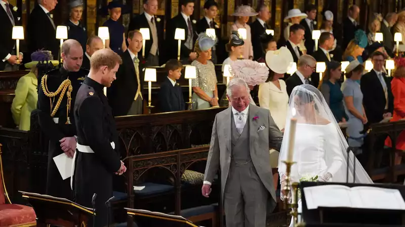 Prince Charles frames a photo of Meghan Markle walking