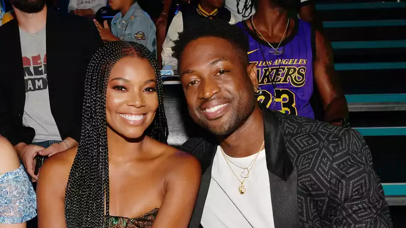 Gabrielle Union, Dwayne Wade, Zaya, and Carvia pose in isolation.