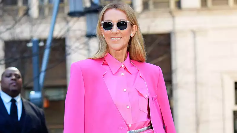 Celine Dion in a bold hot pink ensemble of skirt and wide pants