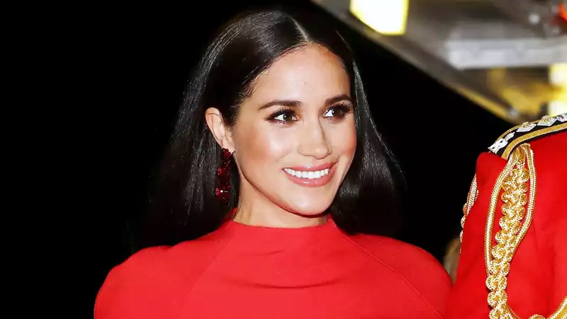 Meghan Markle in a red cape dress at the Mountbatten Music Festival