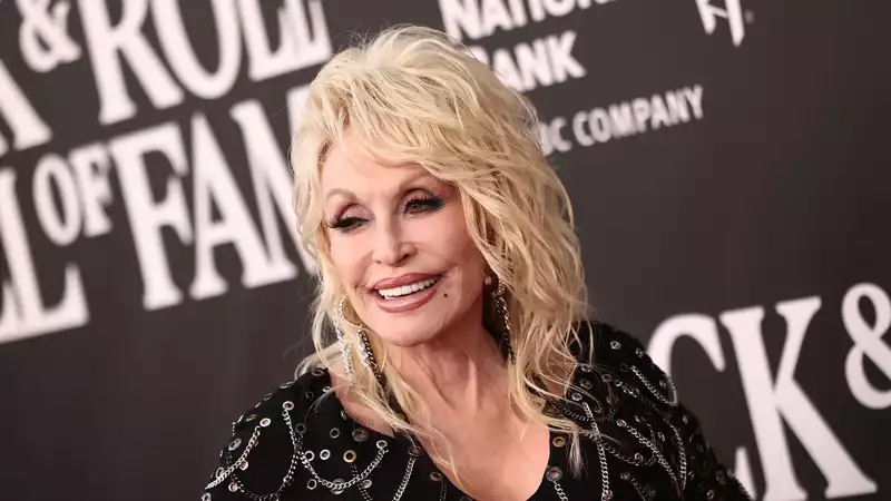 Dolly Parton reveals why she has worn wigs throughout her career.