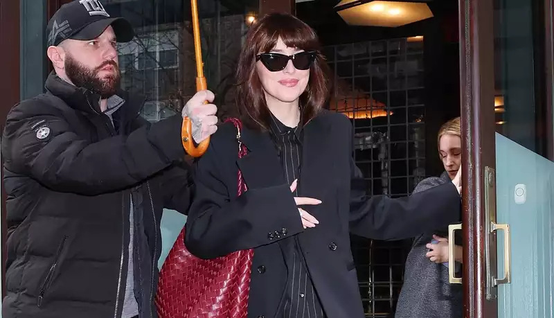 Dakota Johnson's pinstripe power suit bucks the "Mob Wives" trend.