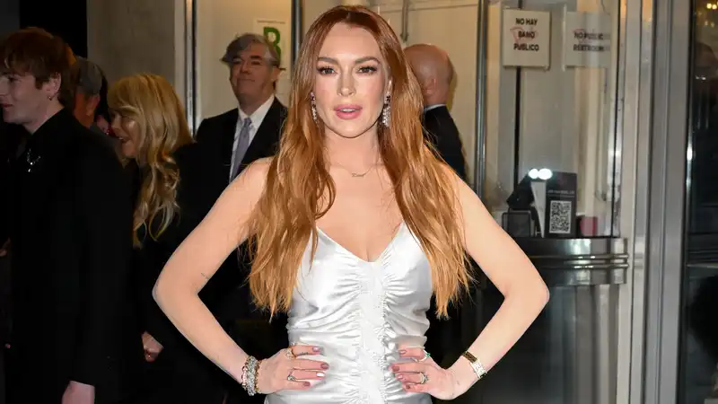 Lindsay Lohan is a textbook Rom-Com heroine in a silver ruched gown.