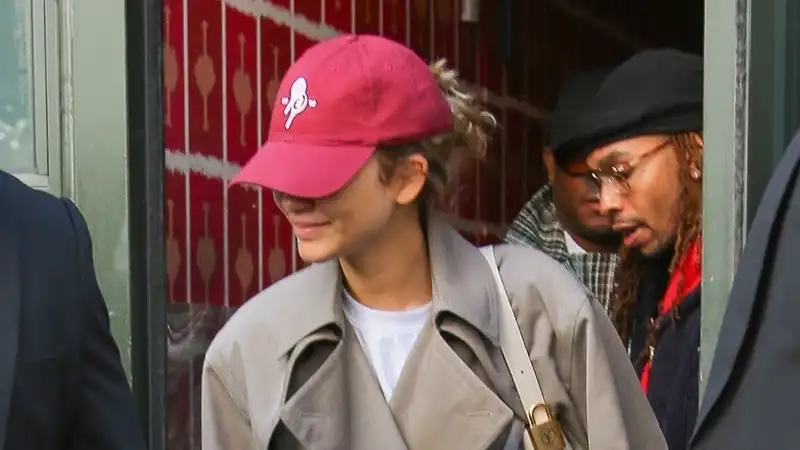 Zendaya winks at "The Challengers" in a classic trench coat