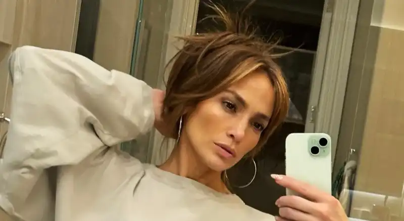 Jennifer Lopez takes a selfie wearing her favorite cropped sweat suit.