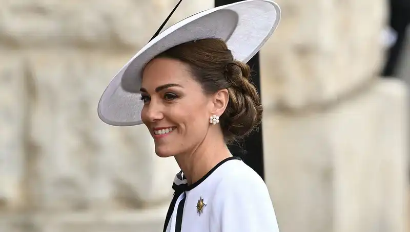 Kate Middleton makes her long-awaited return to "Trooping the Colour" in a white dress with ribbon.