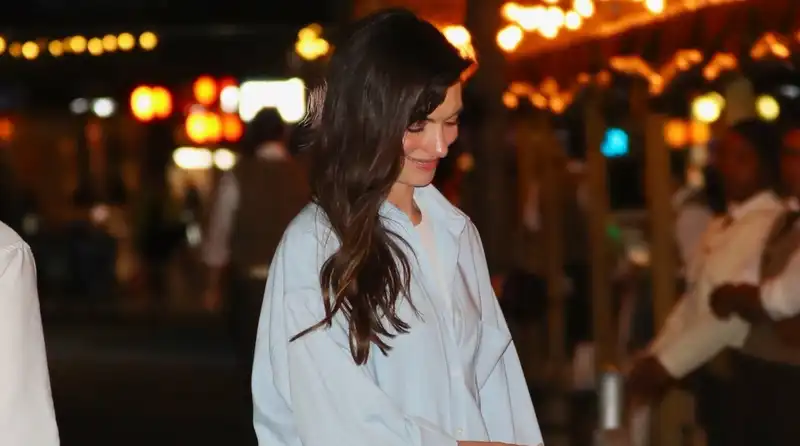 Anne Hathaway dresses up her pajama set with mesh flats and a Birkin bag.