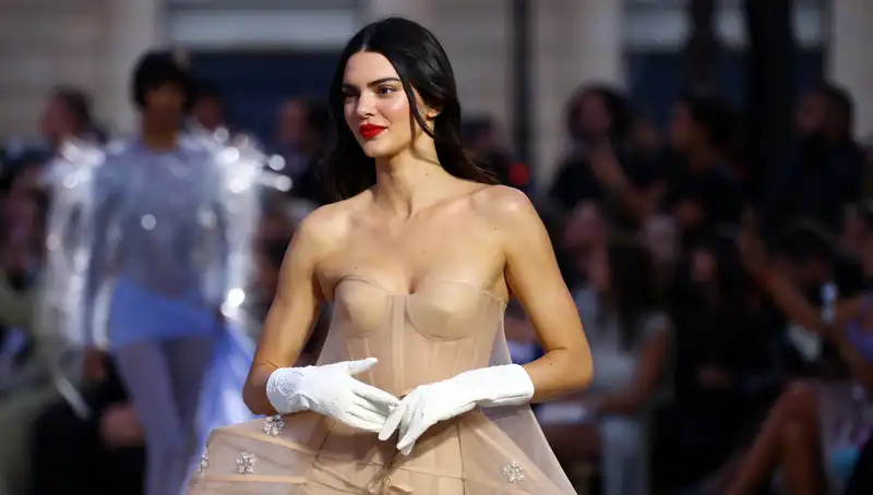 Kendall Jenner barefoot at the Louvre in a romantic black skirt set