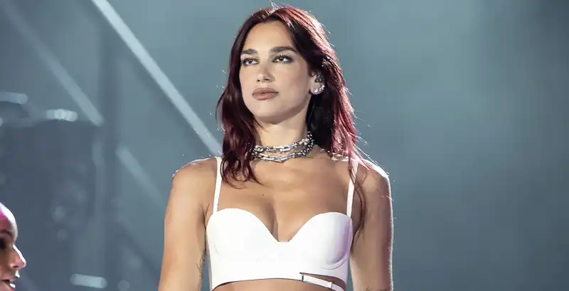 Dua Lipa layers $166,000 worth of Tiffany & Co. necklaces on a music festival cutout dress.