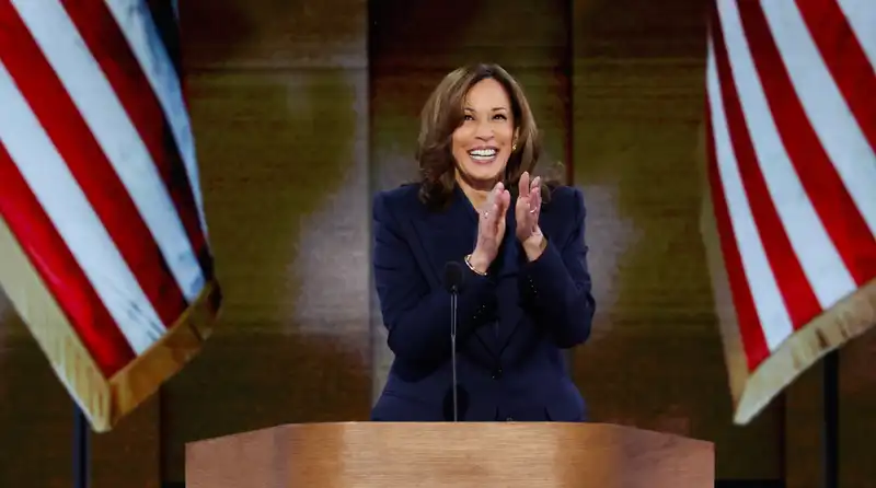 Kamala Harris, in a dark blue power suit, accepts the Democratic presidential nomination.