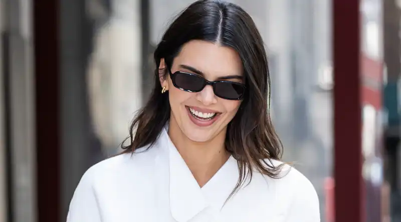 Kendall Jenner styled her all-white U.S. Open outfit with rich accessories.