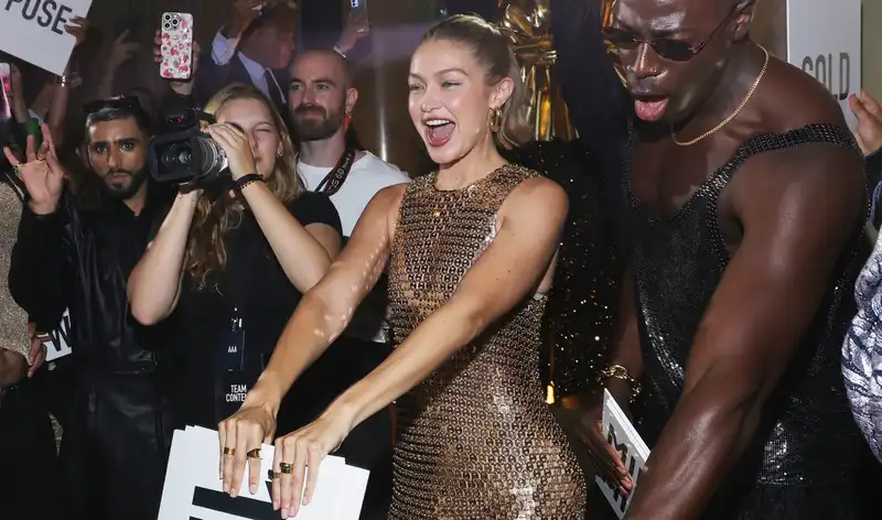 Gigi Hadid's Naked manicure paired with a gold Naked dress at Paris Fashion Week