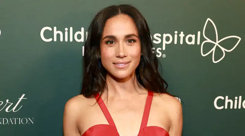 Meghan Markle makes a surprise appearance in Carolina Herrera's red dress.