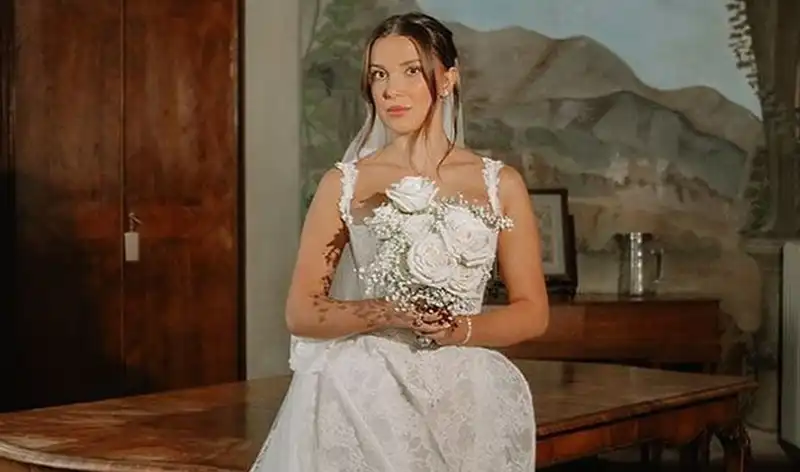 Millie Bobby Brown marries Jake Bongiovi for the second time in a wedding gown by four designers.