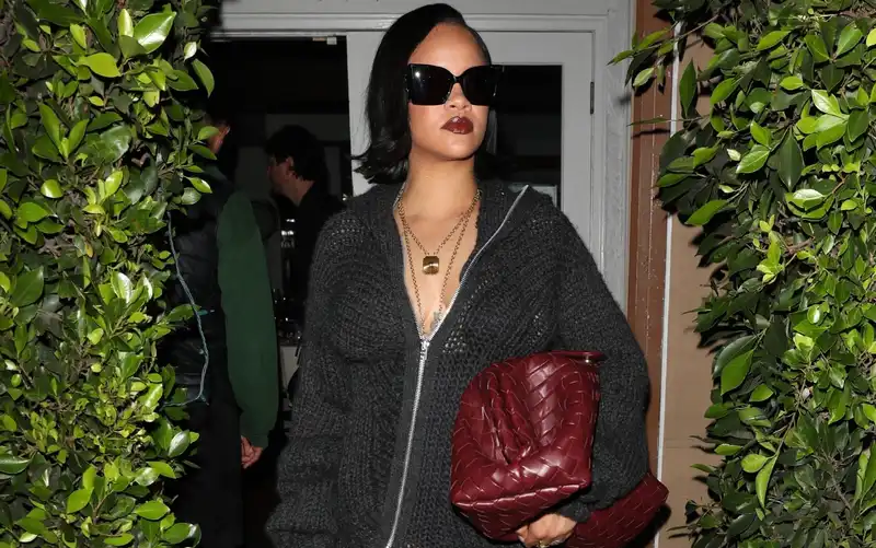 Rihanna shows off her beautiful legs in a see-through sweater dress and thigh-high boots that look like dominatrixes.