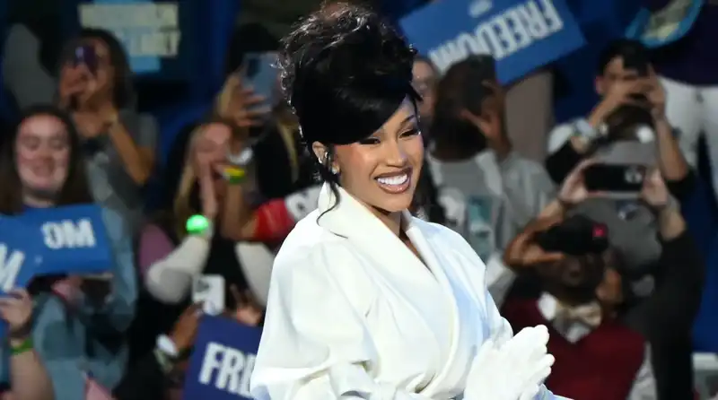 Cardi B. wears a Suffragette-style white power suit while endorsing Vice President Kamala Harris