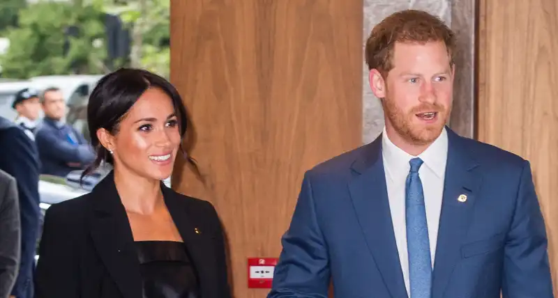 Meghan Markle and Prince Harry make a rare video appearance in matching navy blazers.