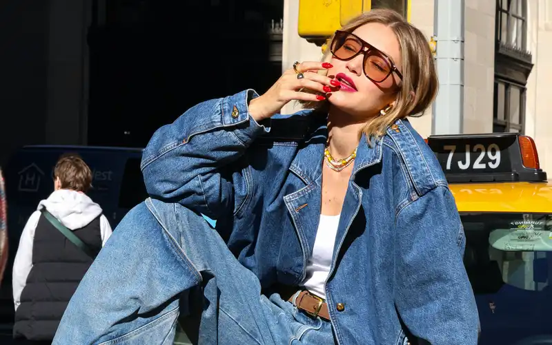 Gigi Hadid matches her lipstick to her cherry red nails for her traffic stop Maybelline shoot