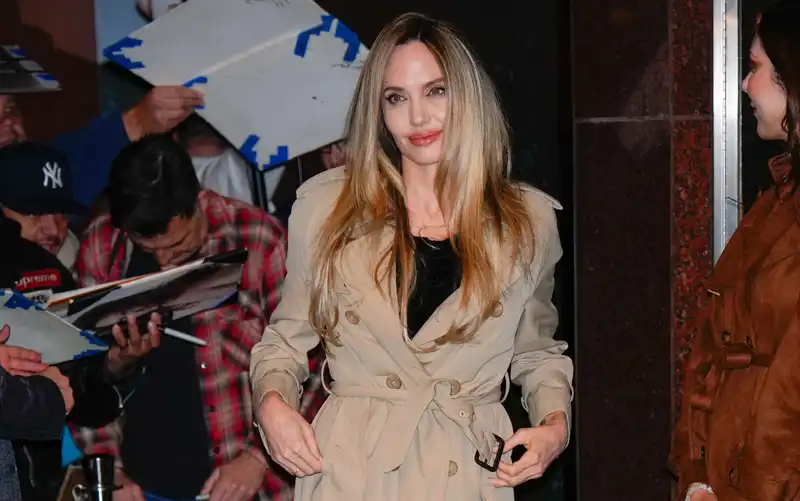 There is nothing between Angelina Jolie and her best designer trench coat