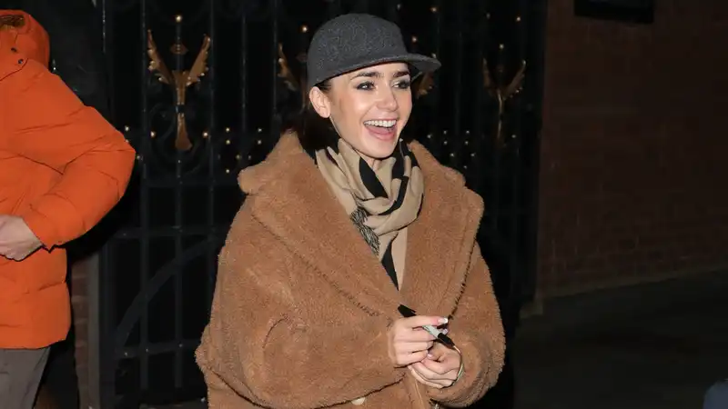 Lily Collins Cozies on the trend of suede Adidas sneakers and plush designer baseball cap Teddy Coat