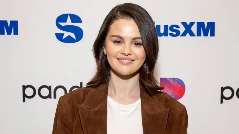 Selena Gomez embraces the suede trend with a trench coat designed by the style icon.