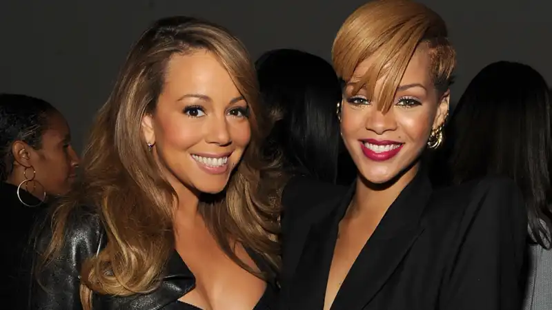 Mariah Carey signs Rihanna's chest at holiday concert