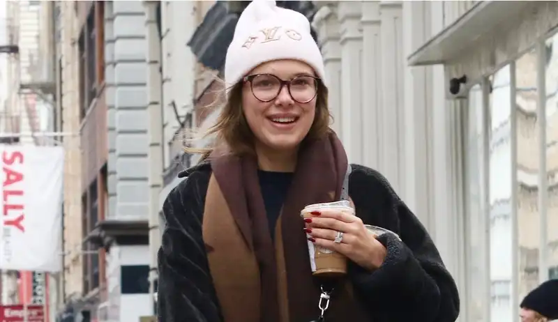 Millie Bobby Brown perfectly matches her poodle with designer moon boots and a $995 Louis Vuitton scarf